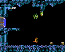 Captura de pantalla d'un videojoc d'un protagonista en un exoesquelet motoritzat, viatjant per una cova mentre monstres alats baixen volant del sostre.