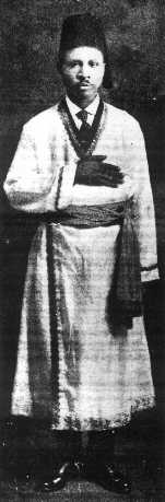 Drew in a long gown with his hand held over his chest