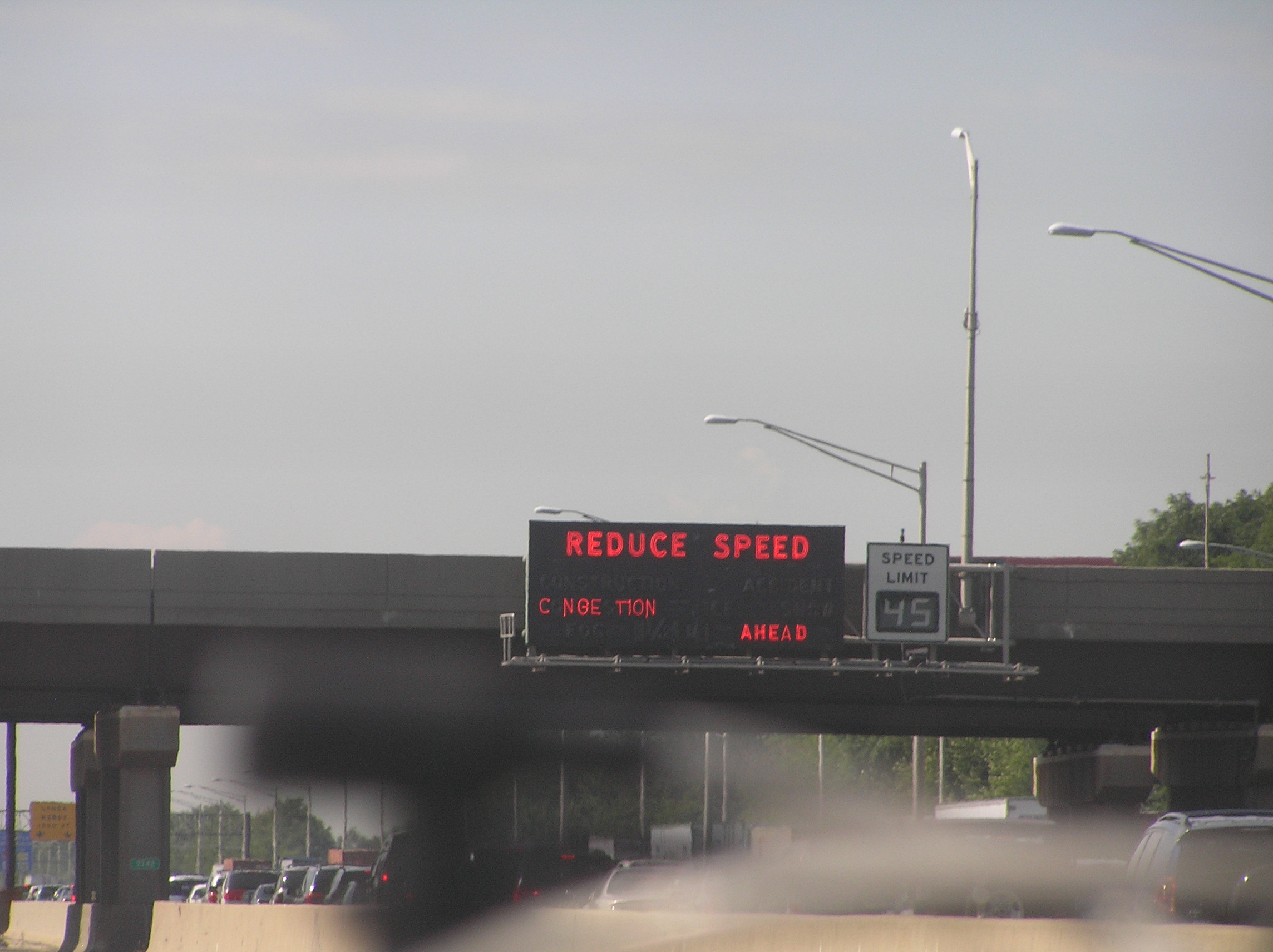 File:NJ Turnpike Reduce Speed signage with portions burned out.jpg