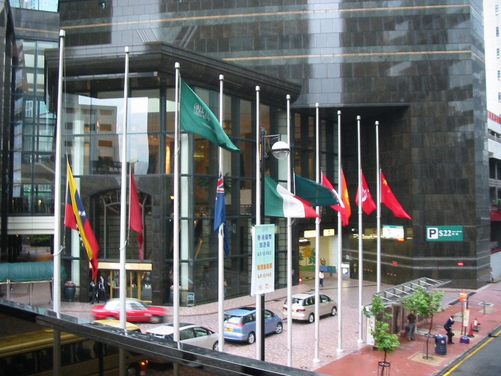 Image of a group of national flags flown at half-staff. 