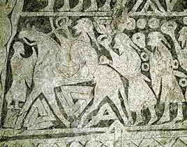 7세기 솅겔고르다 암각화. 고리를 든 전사들의 무리를 한 사람이 말을 타고 인도하고 있고, 그 말 아래에는 발크누트 상징이 있다.