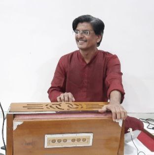 Pandit Shrinivas Acharya playing the Harmonium