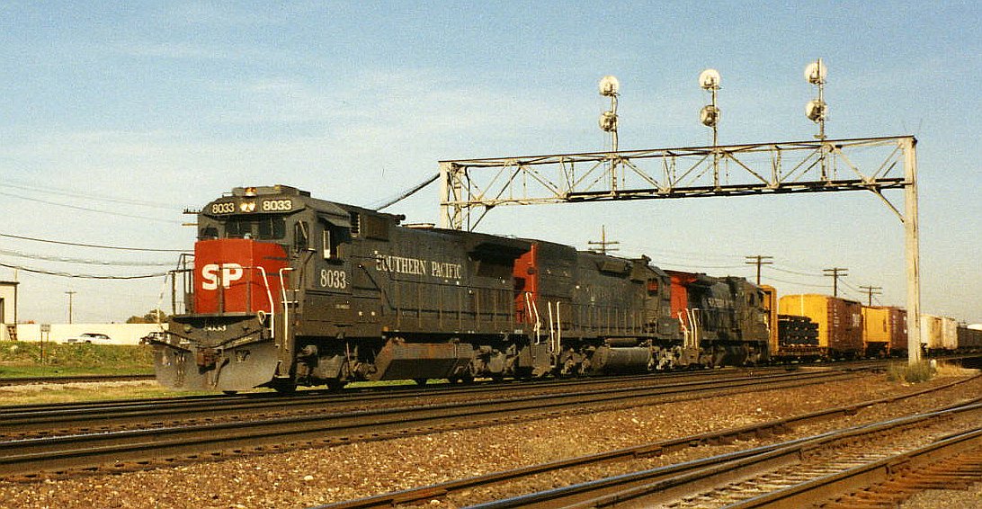SP 8033, a GE Dash 8-39B, leads a westbound train through Eola, Illinois (just east of Aurora), October 6, 1992.