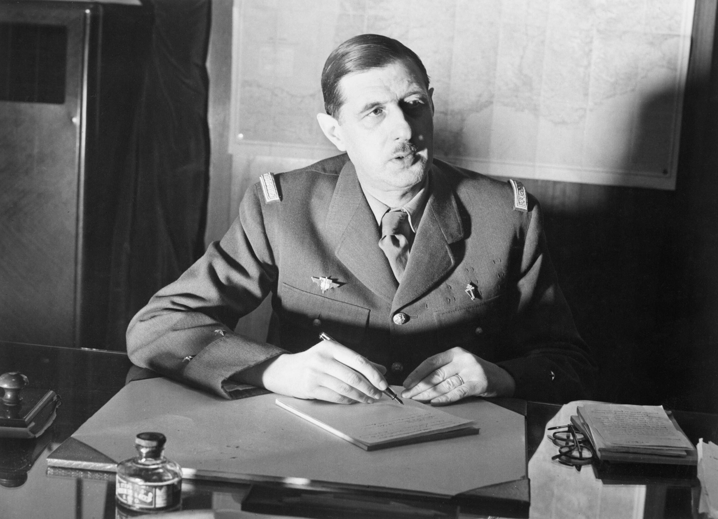 Commander of Free French Forces General Charles de Gaulle seated at his desk in London during the Second World War. D1973