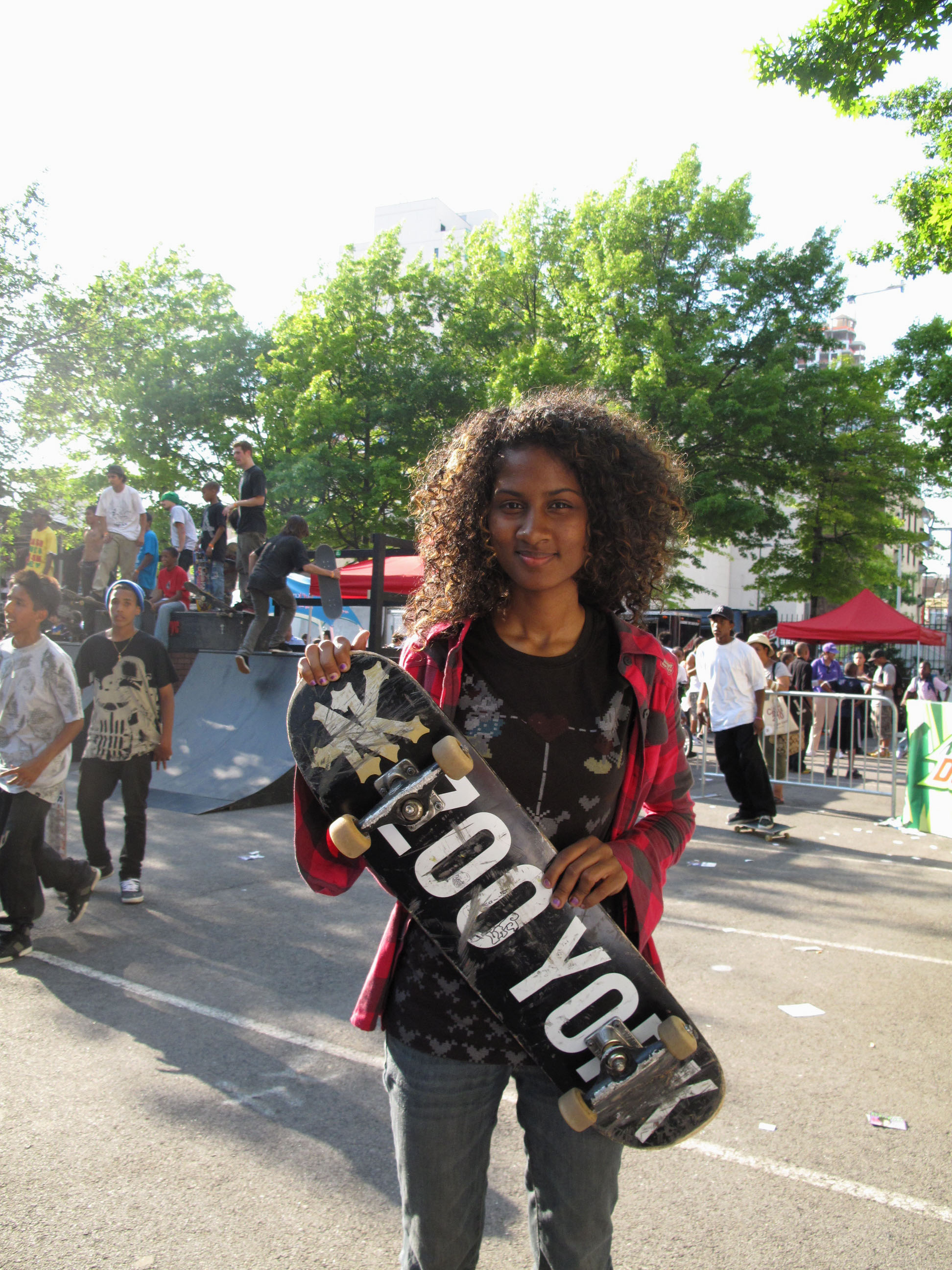 teenage girl holding skateboard