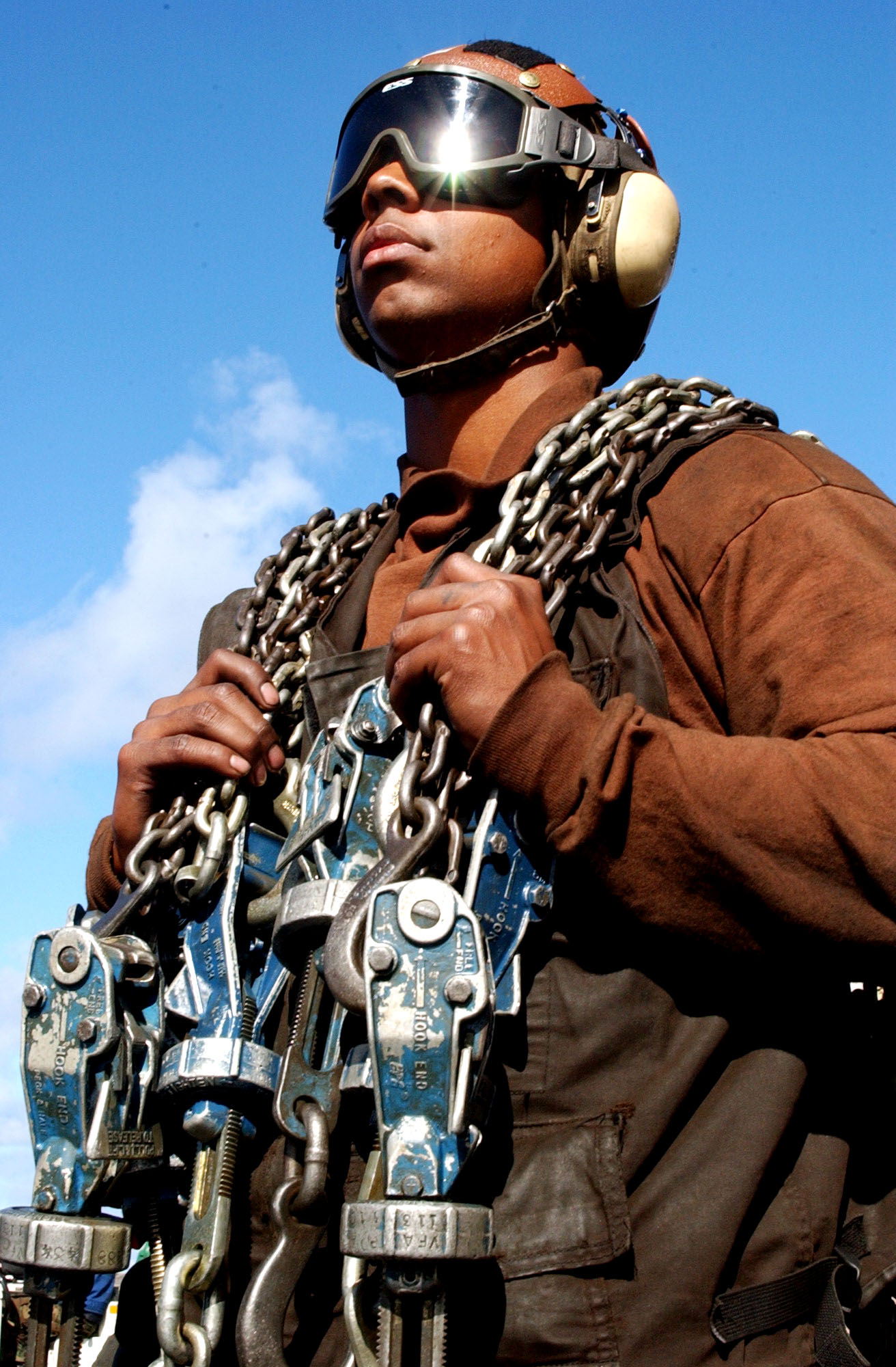 US Navy 031116-N-7732W-169 Aviation Electrician's Mate Airman Daniel Green, from Hume, Va., carries tie-down chains to secure aircraft on the flight deck of the USS John C. Stennis (CVN74).jpg
