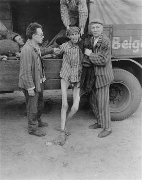 An emaciated survivor is helped into a truck that will transport him from the Woebbelin concentration camp to an American field hospital.jpg