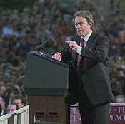 A man on a podium addressing a crowd