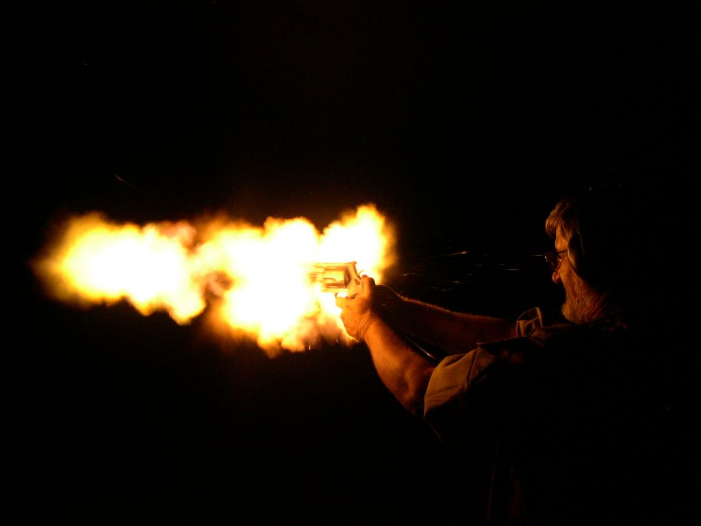 Muzzle flash and cylinder blast from a Smith & Wesson Model 500 fired at night.