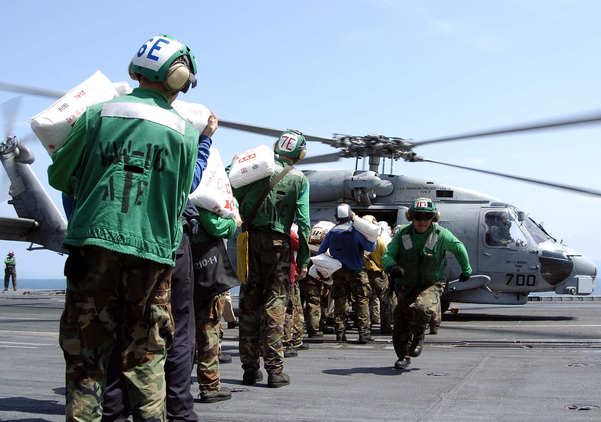 US Navy 050106-N-0057P-051 Bags of rice are loaded onto an SH-60B Seahawk helicopter.jpg