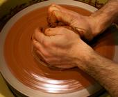 English: An artist "centering" clay ...