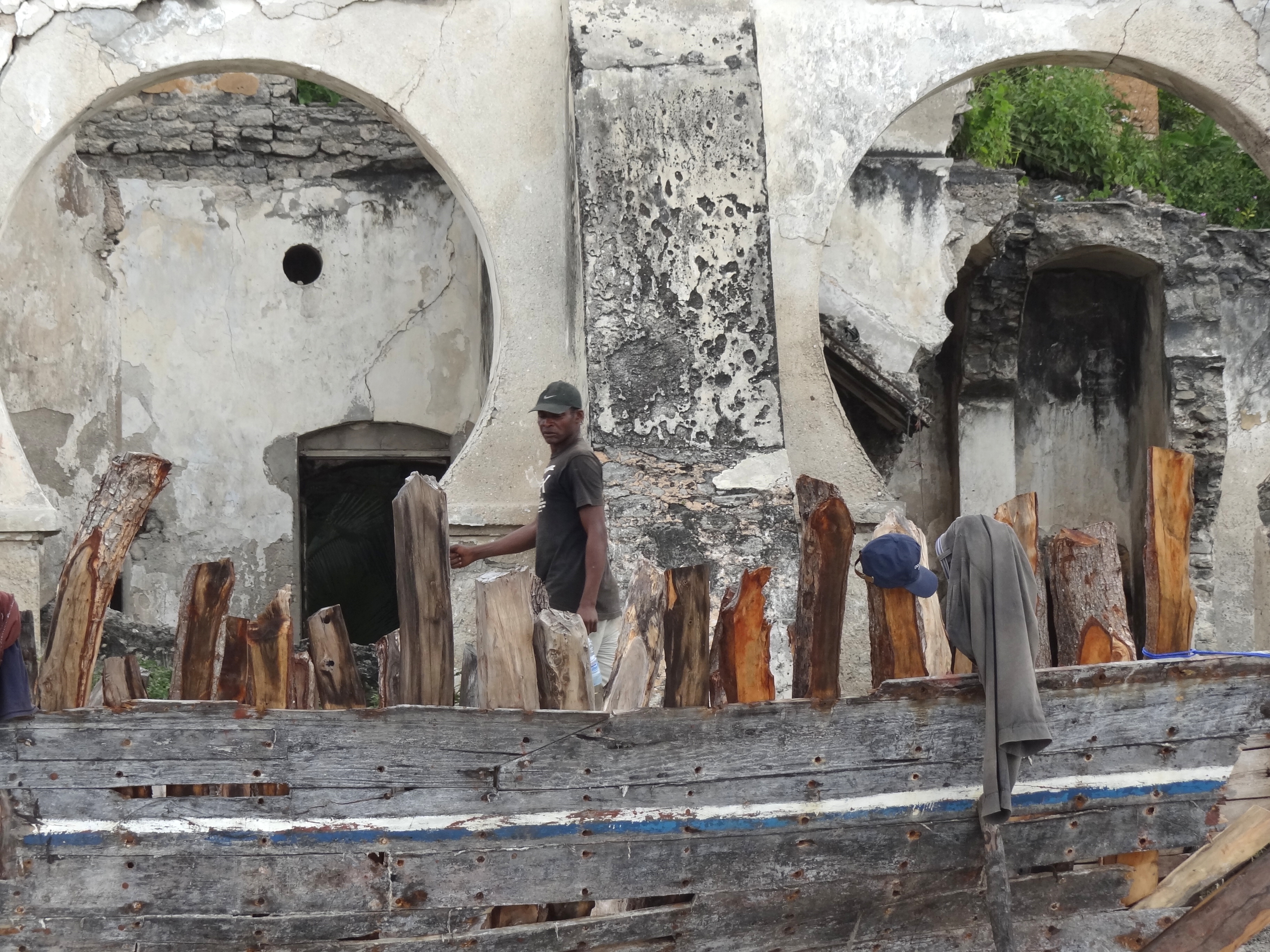 File:Boat under Repair with Passing Man - Fishing Port - Bagamoyo 