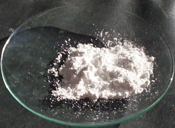 A clear glass dish holds a bright white powder. 