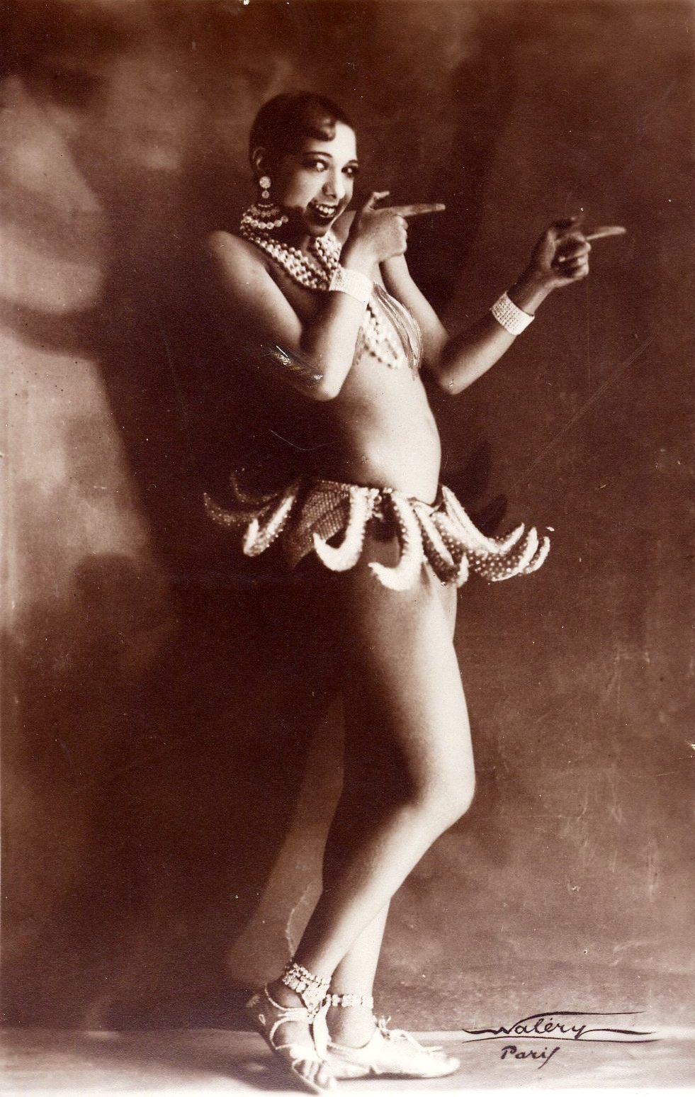 Josephine Baker in Banana Skirt from the Folies Bergère production "Un Vent de Folie," 1927. Picture by Walery, French, (1863-1935). PD by age (Walery died more than 70 years ago). From Wikipedia.