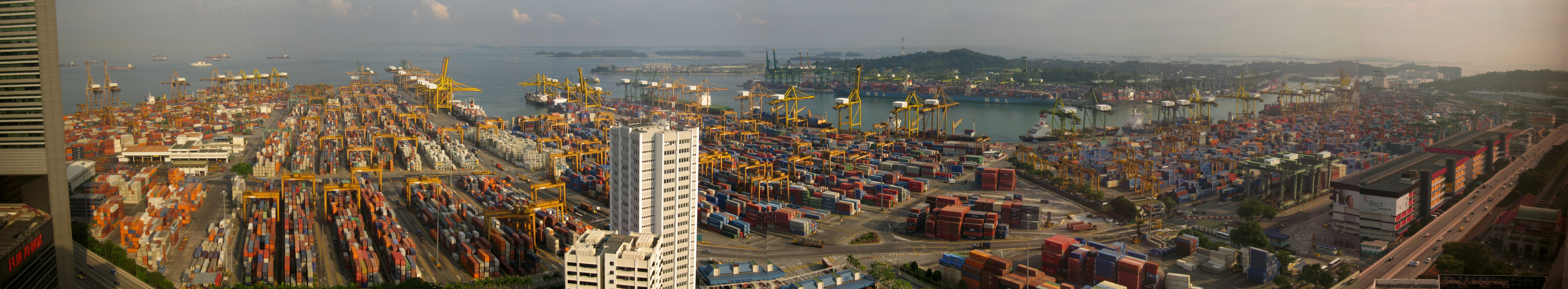 The Port with a large number of shipping containers and the ocean visible in the background