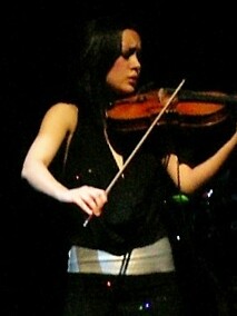 Micarelli playing the violin during Josh Groban's 2007 concert in the Palais des Congrès, in Paris.