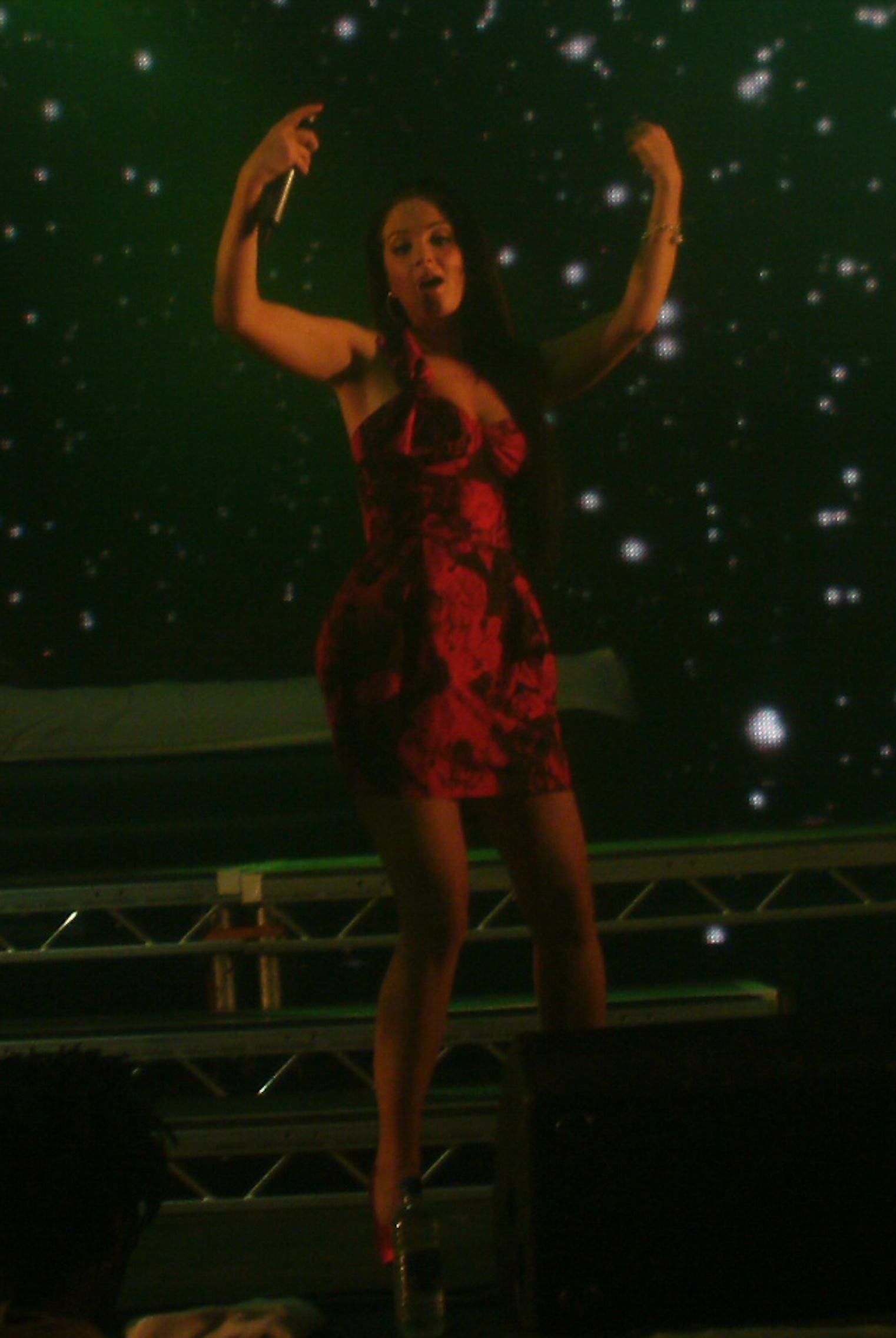 English: Tulisa performing onstage with N-Dubz...
