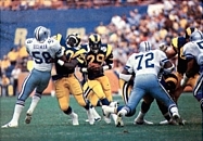 Dickerson (29) rushing through the Cowboys' defense in the 1985 NFC Divisional Playoff game. 1986 Jeno's Pizza - 23 - Eric Dickerson and Barry Redden (cropped).jpg