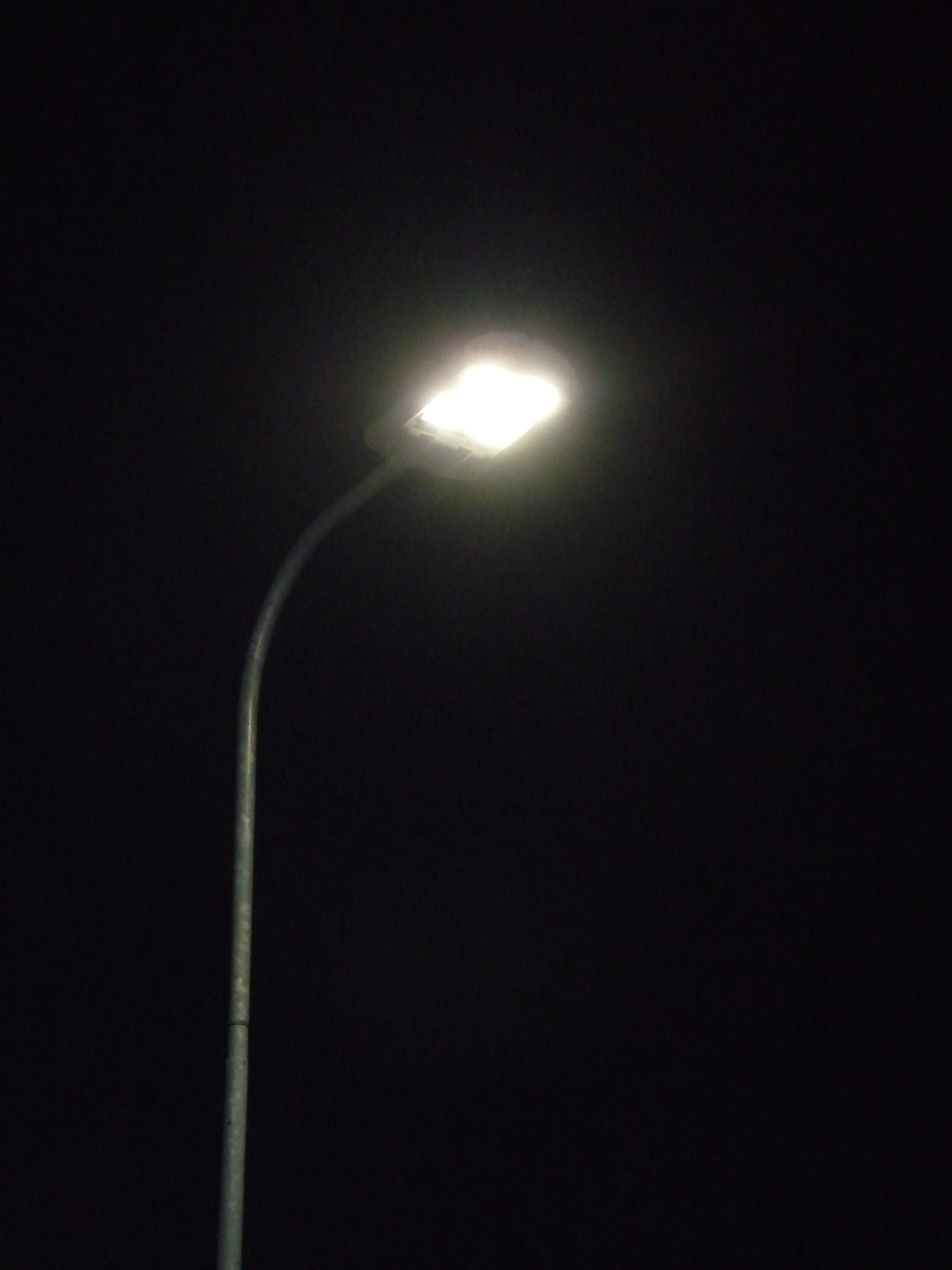 LED streetlight in Talinn, Estonia. LEDs tend to emit cooler, whitish light than fluorescent or incandescent bulbs. Image courtesy of Wikimedia.org user Dmitry G.
