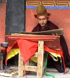Buddhist monk Geshe Konchog Wangdu reads Mahayana sutras from an old woodblock copy of the Tibetan Kanjur.