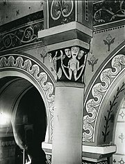 Photo noir et blanc très contrastée d'un chapiteau sculpté et de murs peints