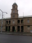 This sandstone building was designed by the architect Sidney Stent and erected by the builders Male and Kirton. The cornerstone was laid on 24 May 1882 by the wife of Mayor D. S. Barrable. Type of site: Town Hall.