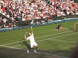 Roger Federer serving in a match against Marat...