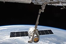 The second mission of the SpaceX Dragon capsule is berthed to the ISS. ISS-31 SpaceX Dragon commercial cargo craft is grappled by Canadarm2.jpg