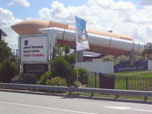 Gate to the KSC Visitor Complex in 2006; Explorer, a Space Shuttle mock-up, is in the background KennedySpaceCentreVisitor'sCentreFrontGate.JPG