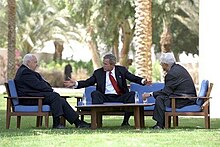 President George W. Bush, center, discusses the peace process with Prime Minister Ariel Sharon of Israel, left, and Palestinian President Mahmoud Abbas in Aqaba, Jordan, 4 June 2003 President George W. Bush meets with Prime Minister Ariel Sharon of Israel and Prime Minister Mahmoud Abbas of the Palestinian Authority.jpg