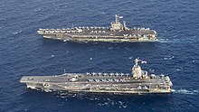 Aerial view of USS Gerald R. Ford (bottom), a ship of the new Gerald R. Ford class, alongside USS Harry S. Truman (top), a ship of the previous Nimitz class USS Gerald R. Ford (CVN-78) and USS Harry S. Truman (CVN-75) underway in the Atlantic Ocean on 4 June 2020 (200604-N-BD352-0199).JPG