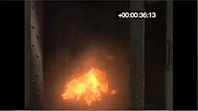 Fire, T2, at 36.13 seconds, as condensed aerosol suppressant is just deployed Wiki 30T generator 02.jpg