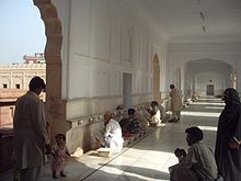 People washing before prayer at Badshahi Mosque in Lahore, Pakistan. Ablution area inside Eastern wall of Badshahi mosque.JPG