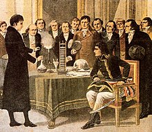 The voltaic pile presented by Alessandro Volta to Napoleone Bonaparte. Alessandro Volta presente sa pile electrique a Napoleon en 1801.jpg