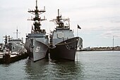 Ticonderoga-class cruisers (right) were built on the same hull as the Spruance-class destroyer (left). Bow view of USS Spruance (DD-963) and USS Ticonderoga (CG-47) at Naval Station Norfolk on 8 October 1983 (6397938).jpg