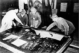 The Ghent Altarpiece during recovery from the Altaussee salt mine at the end of World War II. The pioneering conservation work on these panels in the 1950s led to advances in methodology and technical application Ghent altarpiece at Altaussee.jpg