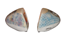 Side view of two iMacs; one has a blue coloring with lighter spots, while the other has multicolored flowers screened on its surface.