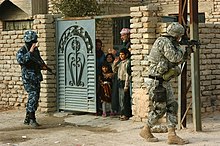 A paratrooper from 505th Infantry conducts joint patrol with an Iraqi policeman in Samarra, Iraq. Patrol in Samarra.jpg