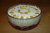 Trifle is an English dessert dish made from layered custard, fruit, sponge cake, fruit juice or jelly, and whipped cream.