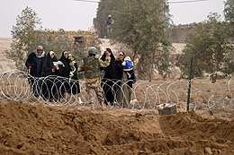 Nasarwasalam, Iraq, January 30, 2005. Iraqi women set out to vote in the first free elections held in Iraq. Security for the polling site was provided by the Iraqi Security Force (ISF) and members of the US Marines Corps. US Navy 050130-M-7981G-020 Iraqi citizens come out in masses to vote for the first ever Free Elections in Iraq.jpg