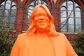 closeup of the orange, horizontally striated face of one of the statues