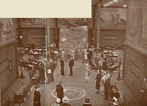 A crowd admires the murals and electric map at the Ohio State Exhibit.