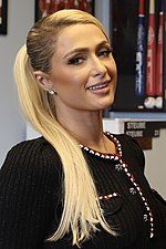 A photo of Paris Hilton posing in an office.