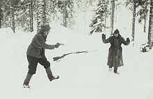Soviet soldier surrenders to a Finnish soldier during the Continuation War. The photo may have been staged. Vihollinen antautuu.jpg