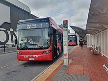 Red bus stopped at bus station