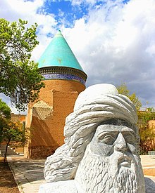 Bust of Hamdallah Mustawfi in Qazvin. His mausoleum lies in the background