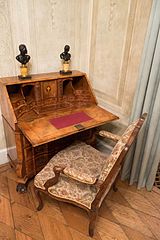 Antique writing desk with hinged writing surface