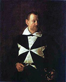 Portrait en demi-figure d'un homme barbu vêtu d'un habit noir frappé de la croix de Malte