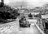 German Panzerspähwagen Sd.Kfz. 231 armoured car descending from Marjan Hill, with the city in the background.