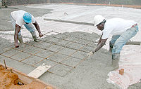 Installing rebar in a floor slab during a concrete pour